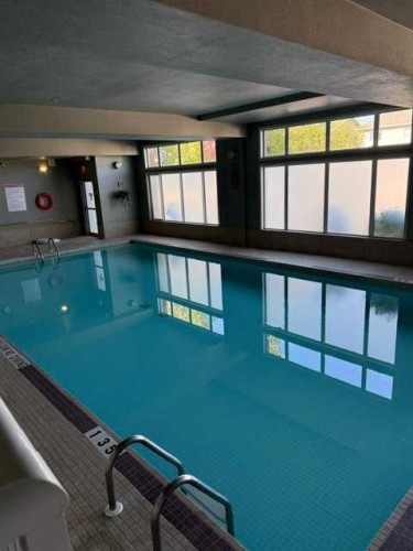 203-15 Everstone Drive Sw, Calgary, AB - Indoor Photo Showing Other Room With In Ground Pool