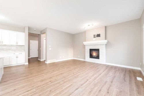 243 Kinniburgh Road, Chestermere, AB - Indoor Photo Showing Living Room With Fireplace