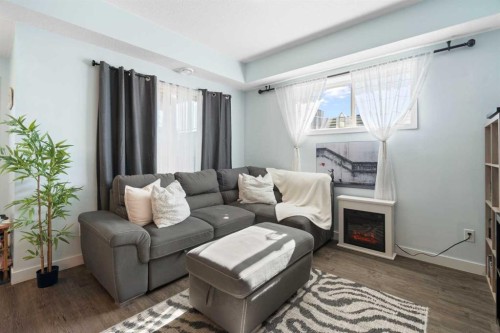 1104-2461 Baysprings Link Sw, Airdrie, AB - Indoor Photo Showing Living Room With Fireplace