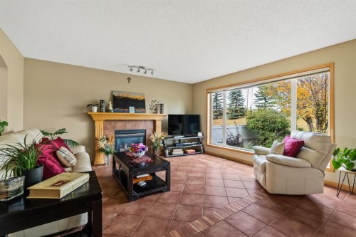 120 Simcoe Close Sw, Calgary, AB - Indoor Photo Showing Living Room With Fireplace