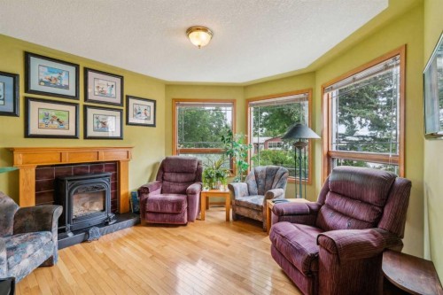 2506 19 Street, Nanton, AB - Indoor Photo Showing Living Room With Fireplace