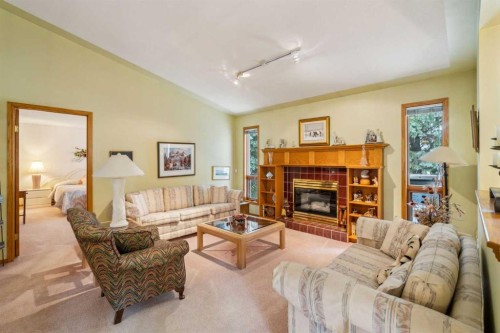 2506 19 Street, Nanton, AB - Indoor Photo Showing Living Room With Fireplace