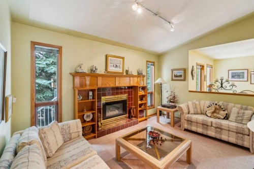 2506 19 Street, Nanton, AB - Indoor Photo Showing Living Room With Fireplace