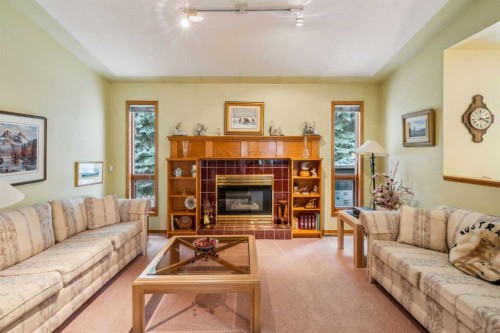 2506 19 Street, Nanton, AB - Indoor Photo Showing Living Room With Fireplace