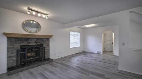 160 Riverstone Crescent Se, Calgary, AB - Indoor Photo Showing Living Room With Fireplace