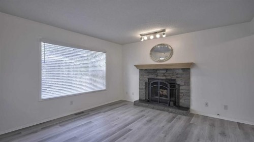 160 Riverstone Crescent Se, Calgary, AB - Indoor Photo Showing Living Room With Fireplace