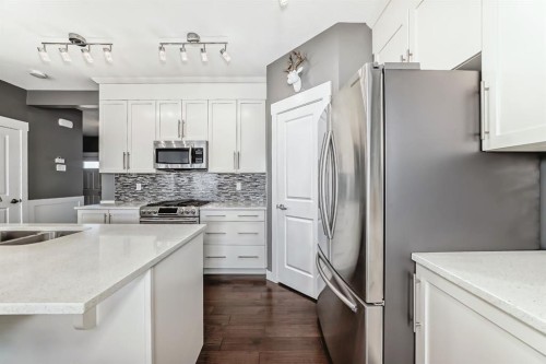 288 Rainbow Falls Green, Chestermere, AB - Indoor Photo Showing Kitchen With Stainless Steel Kitchen With Double Sink With Upgraded Kitchen