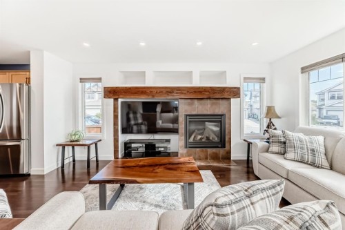182 Sunset Heights, Cochrane, AB - Indoor Photo Showing Living Room With Fireplace