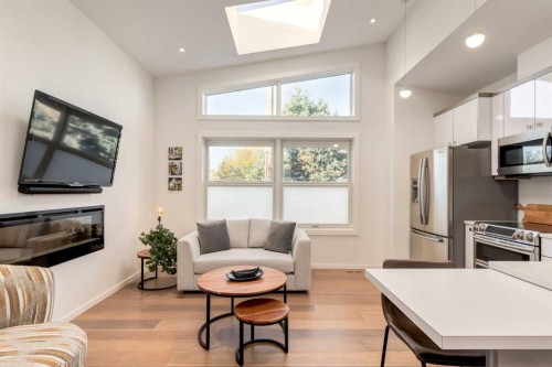 134 6 Avenue Nw, Calgary, AB - Indoor Photo Showing Living Room With Fireplace