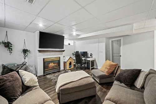 52 West Edge Road, Cochrane, AB - Indoor Photo Showing Other Room With Fireplace