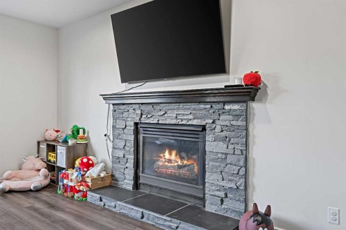 52 West Edge Road, Cochrane, AB - Indoor Photo Showing Living Room With Fireplace