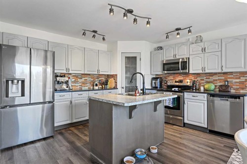 52 West Edge Road, Cochrane, AB - Indoor Photo Showing Kitchen With Stainless Steel Kitchen With Upgraded Kitchen