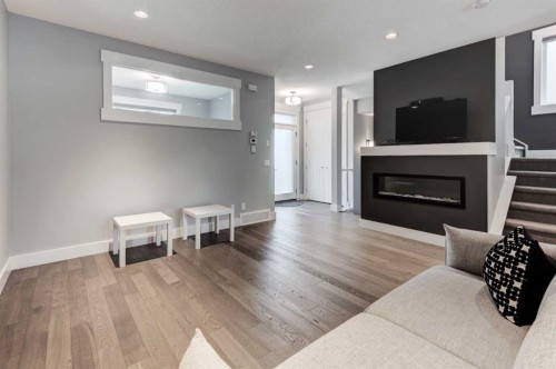 112 Burma Star Road Sw, Calgary, AB - Indoor Photo Showing Living Room With Fireplace