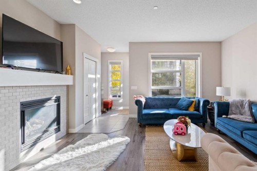128 Livingston Parade Ne, Calgary, AB - Indoor Photo Showing Living Room With Fireplace