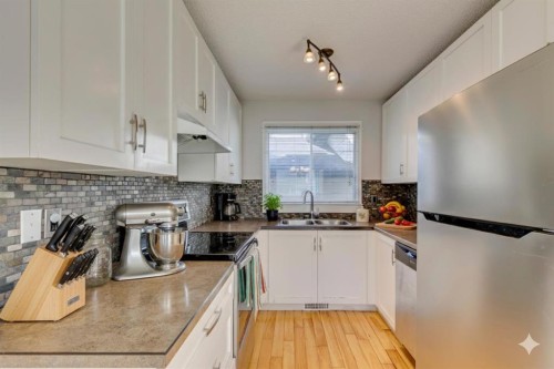 108 Sunbank Way Se, Calgary, AB - Indoor Photo Showing Kitchen With Double Sink