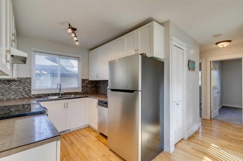 108 Sunbank Way Se, Calgary, AB - Indoor Photo Showing Kitchen With Double Sink