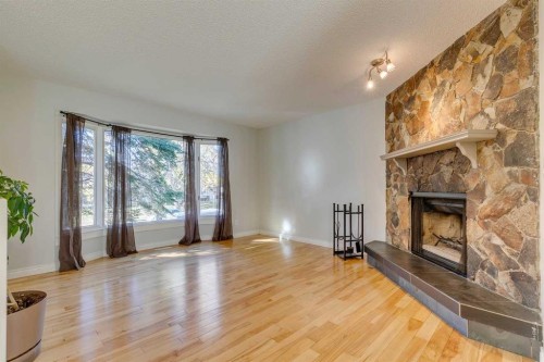 108 Sunbank Way Se, Calgary, AB - Indoor Photo Showing Living Room With Fireplace