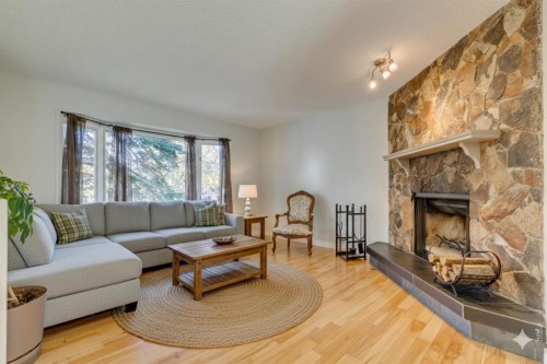 108 Sunbank Way Se, Calgary, AB - Indoor Photo Showing Living Room With Fireplace