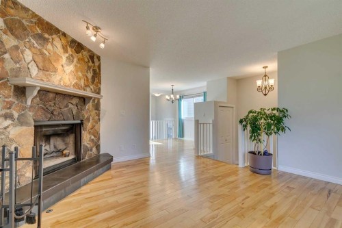 108 Sunbank Way Se, Calgary, AB - Indoor Photo Showing Living Room With Fireplace