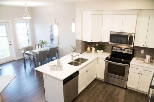 27 Heritage Heath, Cochrane, AB - Indoor Photo Showing Kitchen With Double Sink With Upgraded Kitchen
