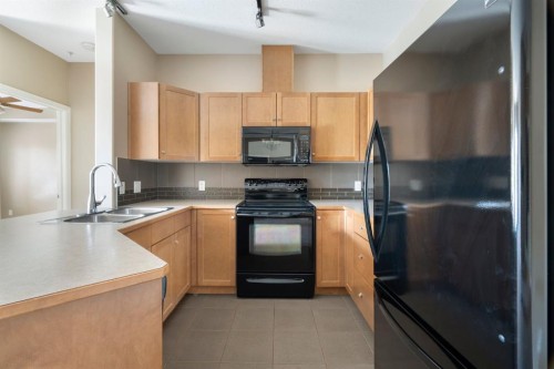 4214-92 Crystal Shores Road, Okotoks, AB - Indoor Photo Showing Kitchen With Double Sink