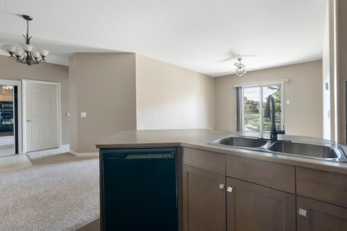 4214-92 Crystal Shores Road, Okotoks, AB - Indoor Photo Showing Kitchen With Double Sink