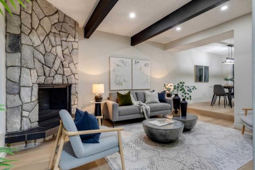 4-7166 18 Street Se, Calgary, AB - Indoor Photo Showing Living Room With Fireplace