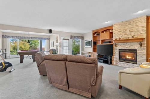 108 Hamptons Heights Nw, Calgary, AB - Indoor Photo Showing Living Room With Fireplace