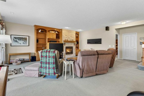 108 Hamptons Heights Nw, Calgary, AB - Indoor Photo Showing Other Room With Fireplace