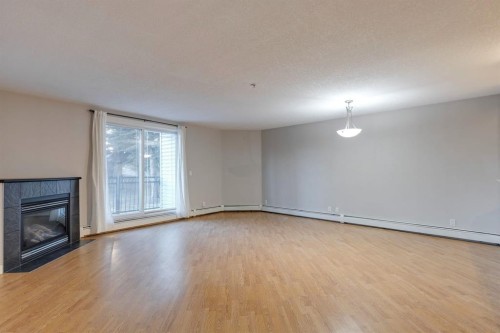 107-2440 34 Avenue Sw, Calgary, AB - Indoor With Fireplace