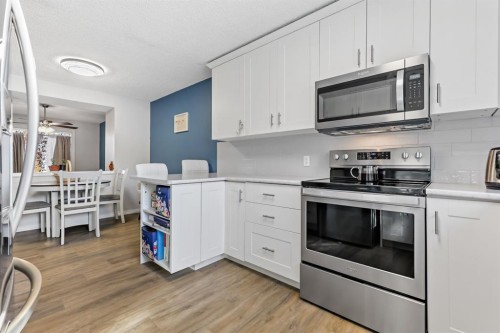 8-7 Westland Road, Okotoks, AB - Indoor Photo Showing Kitchen With Stainless Steel Kitchen
