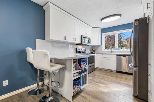 8-7 Westland Road, Okotoks, AB - Indoor Photo Showing Kitchen With Stainless Steel Kitchen