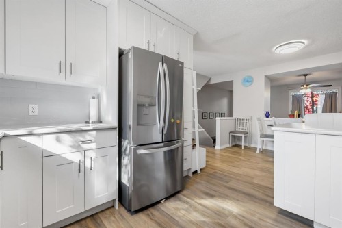 8-7 Westland Road, Okotoks, AB - Indoor Photo Showing Kitchen With Stainless Steel Kitchen