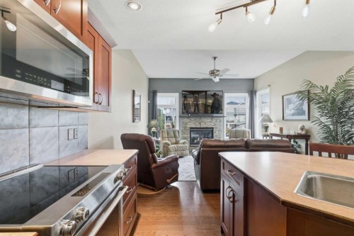 788 Luxstone Landing Sw, Airdrie, AB - Indoor Photo Showing Kitchen With Fireplace
