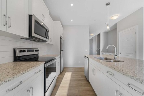 129 Hotchkiss Way Se, Calgary, AB - Indoor Photo Showing Kitchen With Double Sink With Upgraded Kitchen