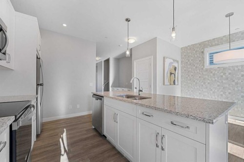 129 Hotchkiss Way Se, Calgary, AB - Indoor Photo Showing Kitchen With Double Sink With Upgraded Kitchen