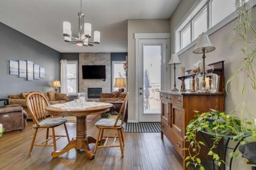 109 Amery Crescent, Crossfield, AB - Indoor Photo Showing Dining Room With Fireplace