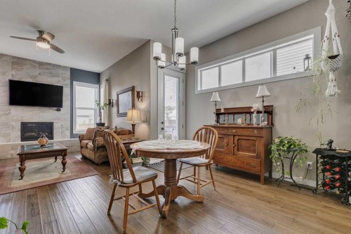 109 Amery Crescent, Crossfield, AB - Indoor Photo Showing Dining Room With Fireplace