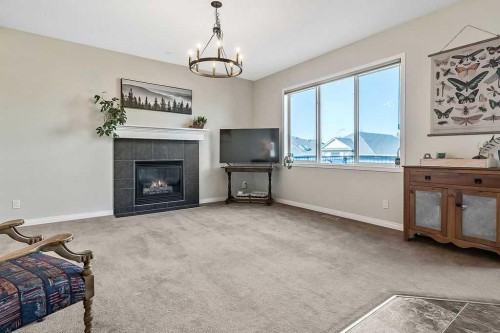 394 Cimarron Boulevard, Okotoks, AB - Indoor Photo Showing Living Room With Fireplace