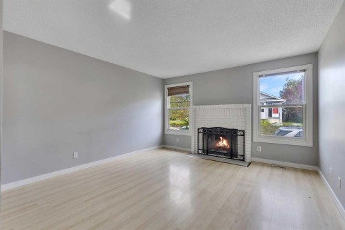 164 Deerview Way Se, Calgary, AB - Indoor Photo Showing Living Room With Fireplace