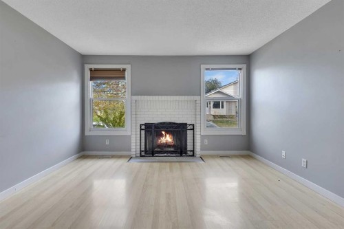 164 Deerview Way Se, Calgary, AB - Indoor Photo Showing Living Room With Fireplace