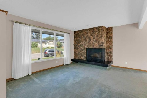 4808 Nordegg Crescent Nw, Calgary, AB - Indoor Photo Showing Living Room With Fireplace
