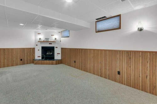 4808 Nordegg Crescent Nw, Calgary, AB - Indoor Photo Showing Other Room With Fireplace