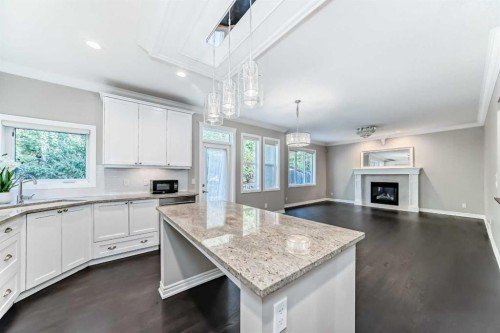 173 Aspenshire Drive Sw, Calgary, AB - Indoor Photo Showing Kitchen With Fireplace