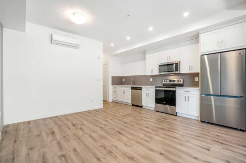 202-20 Sage Hill Nw, Calgary, AB - Indoor Photo Showing Kitchen With Stainless Steel Kitchen With Upgraded Kitchen