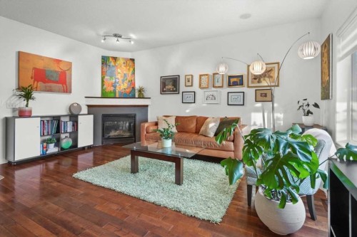 110 Cougar Ridge Circle Sw, Calgary, AB - Indoor Photo Showing Living Room With Fireplace