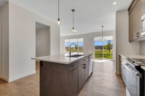 211 Creekstone Row Sw, Calgary, AB - Indoor Photo Showing Kitchen With Double Sink With Upgraded Kitchen