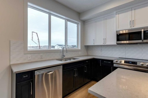 330 Sundown Road, Cochrane, AB - Indoor Photo Showing Kitchen With Double Sink