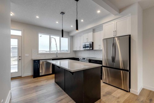 330 Sundown Road, Cochrane, AB - Indoor Photo Showing Kitchen With Upgraded Kitchen