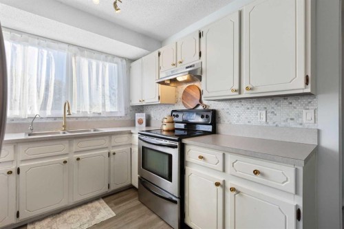 27 Deercrest Close Se, Calgary, AB - Indoor Photo Showing Kitchen With Double Sink